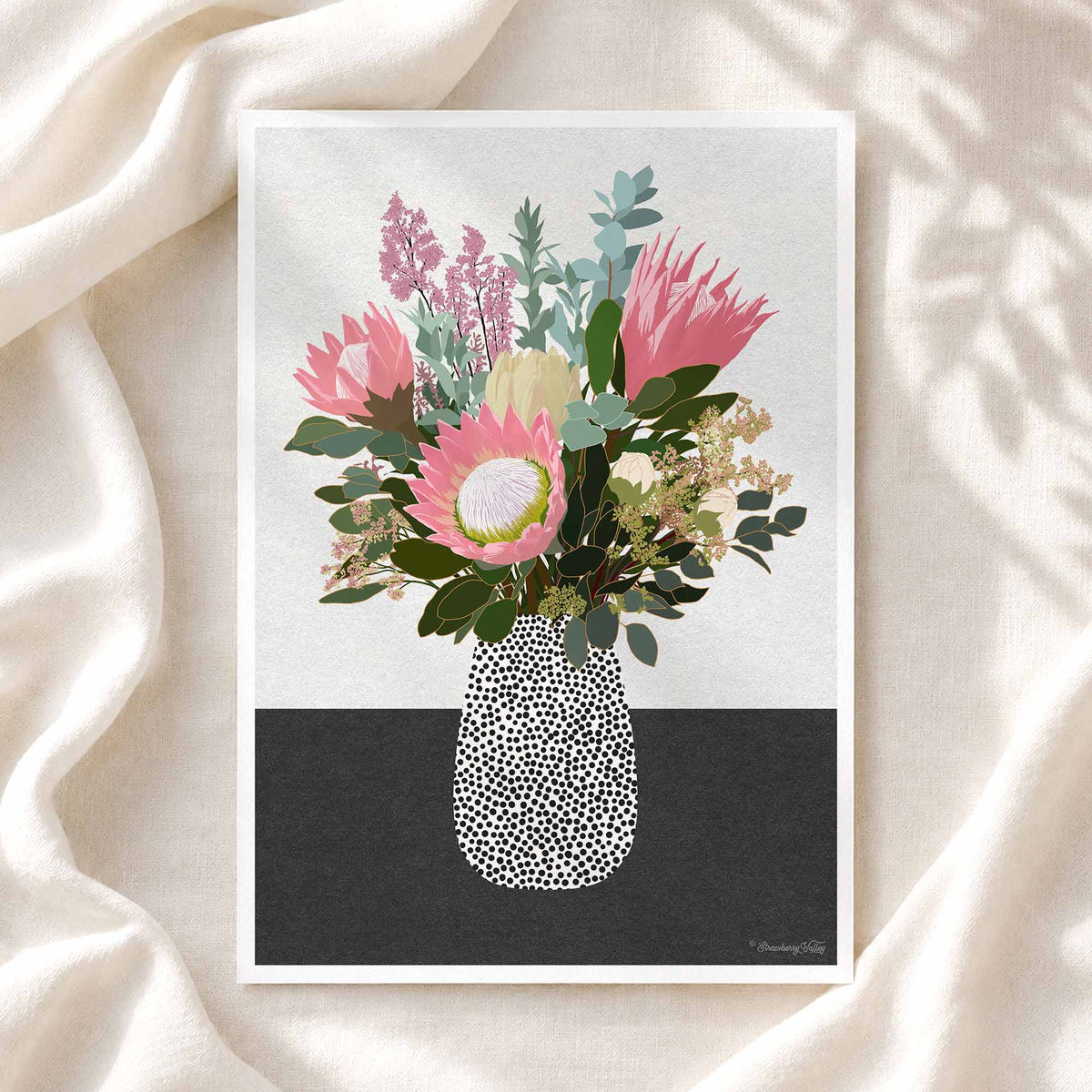 A vertical art print featuring a stylized floral bouquet in a speckled vase, displayed on draped cream fabric with soft shadow overlays. The print has a white border, with the artwork showing pink and green flowers against a split white and dark gray background.